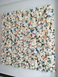 a white wall covered in lots of flowers