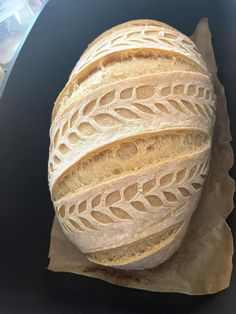 a loaf of bread sitting on top of a piece of wax paper in a container