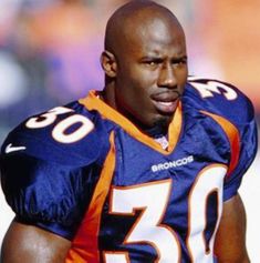 a close up of a football player wearing an orange and blue uniform