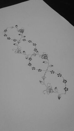 a drawing of flowers and leaves on a sheet of paper that has been drawn by someone