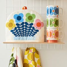 two mugs and some napkins on a shelf