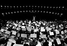 an orchestra with lots of instruments and conductor