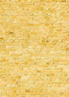 an old yellow brick wall textured with paint