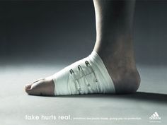 an advertisement for adidas featuring a woman's foot with bandages on it