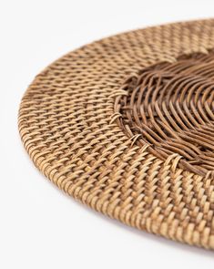 a close up of a straw hat on a white surface