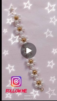 an image of a bracelet with pearls and gold beads on the end, in front of white stars