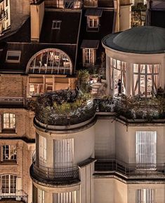 an aerial view of a building with many windows and balconies on the roof