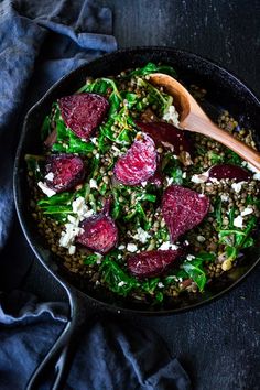 beets, spinach and feta salad in a skillet with a wooden spoon