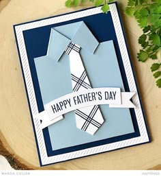 a father's day card with an origami tie on it and some green leaves