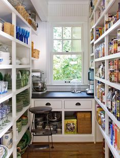 a kitchen with lots of shelves filled with dishes