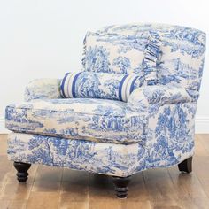 a blue and white chair sitting on top of a hard wood floor