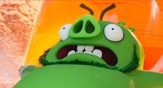 a green angry bird with its mouth open