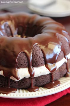 a chocolate bundt cake with white frosting and drizzled on top