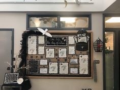 a bulletin board on the wall with pictures and birds hanging from it's sides