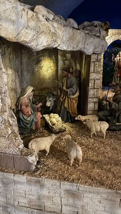 a nativity scene with figurines of people and animals