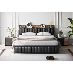 a bedroom with a bed, nightstands and plants