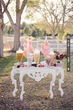 the table is decorated with balloons and candy