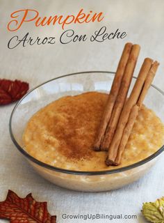 a glass bowl filled with cinnamon and anise on top of a white table cloth