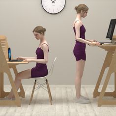 a woman sitting at a desk with a laptop computer in front of her, and another person standing next to the table