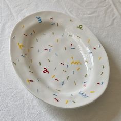 a white plate with sprinkles and numbers on it