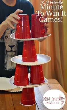 a kid is playing with three red cups on a table and the text reads, 10 minute to win it games