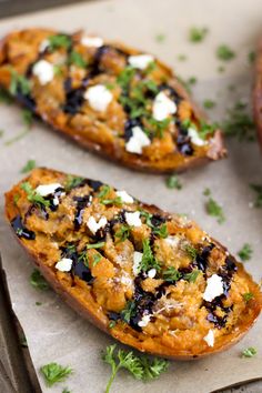 three stuffed sweet potatoes with feta cheese and herbs