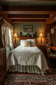 a bed sitting in a bedroom next to two lamps on either side of a window