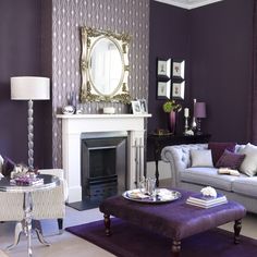 a living room filled with furniture and a fire place in front of a wall mounted mirror