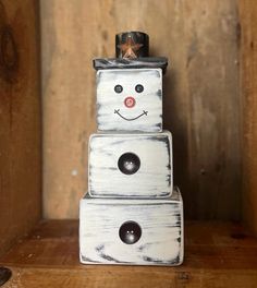 a white wooden block with a smiling face on top