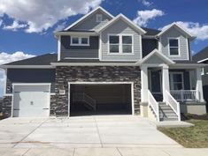 a large house with two garages in the front and one on the other side