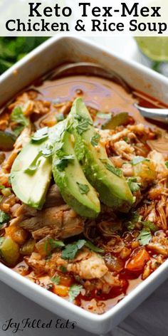 chicken and rice soup in a white bowl with avocado, cilantro