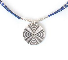 Spiral style. Lose yourself in the vortex design of the hypnotizing sterling silver medallion dangling from this necklace. Not to be upstaged, the necklace boasts a double strand of barrel-shaped blue lapis lazuli beads. From Novica, in association with National Geographic. Lapis Necklace, Lapis Lazuli Beads, Lose Yourself, Blue Lapis Lazuli, Blue Lapis, Artisan Craft, National Geographic, Lapis Lazuli, Beaded Necklace