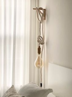 a light bulb hanging from the side of a bed