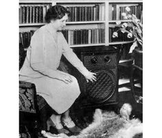 a woman sitting in a chair next to a dog