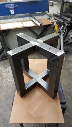 a table that has some kind of metal structure on it's stand in a shop