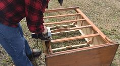 a man is working on an unfinished bed frame