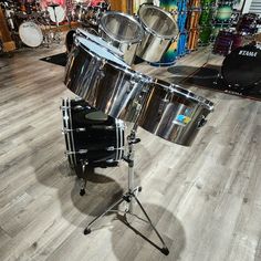 a drum set up on a wooden floor in a room