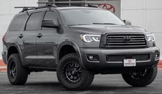 a gray truck parked in front of a building