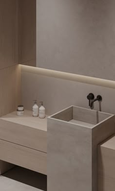 a modern bathroom with two sinks and counter tops in light wood, white and grey tones