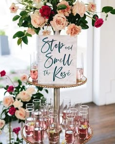 an image of a cake with wine glasses on it and flowers in the bottom right corner