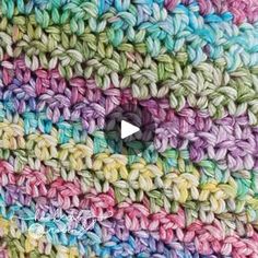 the crocheted blanket is multicolored and has a small hole in it