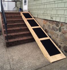 a wooden ramp sitting on the side of a house