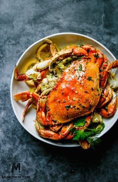 a plate with cooked crab and vegetables on it