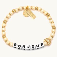 As Emily would say, A little ‘bonjour’ goes a long way". Channel her cheerful personality with the return of our beloved “Bonjour” bracelet featuring a quintessentially Parisian croissant casted bead. Add a touch of Parisian charm to your style and make every day more magnifique Parisian Croissant, Hostess Snacks, Little Words Project, Swimsuit Jewelry, Paris Bracelet, Drinking Accessories, Vacay Outfits, Project X, Jeweled Earrings