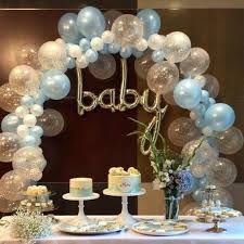 a white table topped with cake and balloons