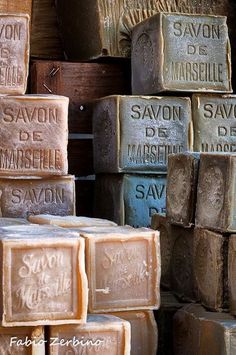 soaps are stacked on top of each other in different colors and sizes, with the words savon de marques written on them