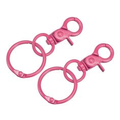 two pink plastic o - rings are shown on a white background