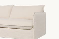 a white couch with two pillows on it