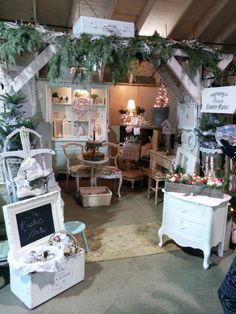 a room filled with lots of furniture and christmas decorations on display in front of a window