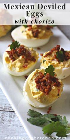 mexican deviled eggs with chorizo and parsley on a white platter